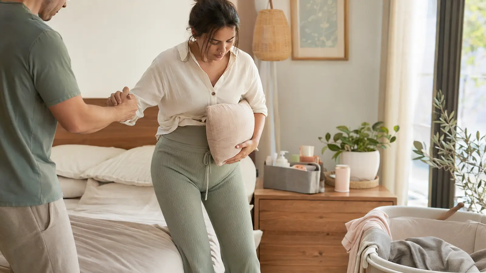 A partner helping a new mother stand comfortably after a C-section